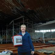 Reverend Heather stood under the leaked church roof.