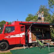 Daniel North and his wife Lucy on top of their campervan, Helga