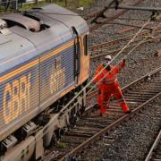 Railway workers at the scene of a freight train derailment in West Ealing, west London