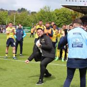 Oxford United head coach Des Buckingham celebrates with the away end at full-time