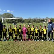 Harwell and Hendred Youth Football Club’s U8 Blacks team in their new away kit sponsored by Vistry Thames Valley. They are pictured with team managers Scott Drewett (left) and Dan Gilder (right).