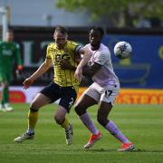 Sam Long tussles with Peterborough United striker Ricky-Jade Jones in the league clash last month