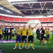 Players celebrate in front of the fans after Wembley triumph