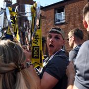 Mark Harris holds the play-off final trophy during the open-top bus tour parade