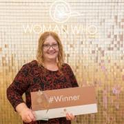 Oxfordshire businesswoman Kate Whitley with a sign saying 'winner'.