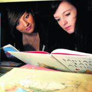 Emily Sweetingham, left, and Natalie Kimberley choosing books to read with young children as part of the reading campaign