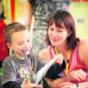 Oxford Mail education reporter Fran Bardsley reads a book with Star Wars fan Sam Scott at St Ebbe’s Primary School