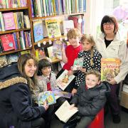 READ ALL ABOUT IT: Volunteers Barbara Posner, left, and Gill Shepherd with St Nicholas Primary School pupils Abigail Earl, seven, Samuel Kelsey, six, Maisie Stansfield, six, and Camren Curtis, seven