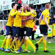 James Constable (centre) is surrounded by his Oxford United teammates after firing the U’s ahead