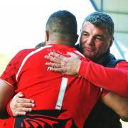 London Welsh head coach Rowland Phillips gives Eddie Aholelei a consoling hug after Saturday’s defeat
