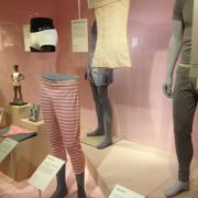 A display case at the Victoria and Albert Museum’s undressed exhibition suggests a shop window
