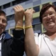 Trevor and Sally Lambert show off their wristbands outside the hospital