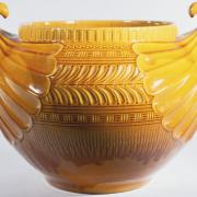 Large burnt ochre jardinire with handles like shells. made at Linthorpe, c.1885, designed by Christopher Dresser, 1,650