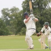 Challow & Childrey captain Ryan Gordon hammers a boundary in his 150 against Sandford St Martin Picture: Steve Wheeler