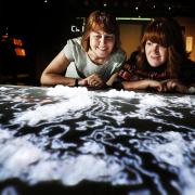 From left the Bodleian's Tolkien Archivist Catherine McIlwaine and Jennifer Varallo with the giant 3D middle-earth map on show. Picture Ed Nix