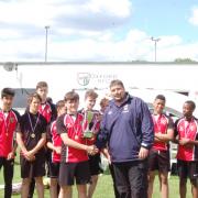 CHAMPIONS: Bartholomew School captain Jacob Moir is presented with the King Charles Cup by Oxford Cavaliers’ head of youth development Jamie Jones