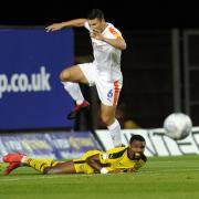 Oxford United's Jon Obika is flattened by a challenge from Luton Town defender Matty Pearson  Picture: David Fleming