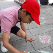 Dwij Mehta, 8, colouring the pavements of Headington at The Big Chalk