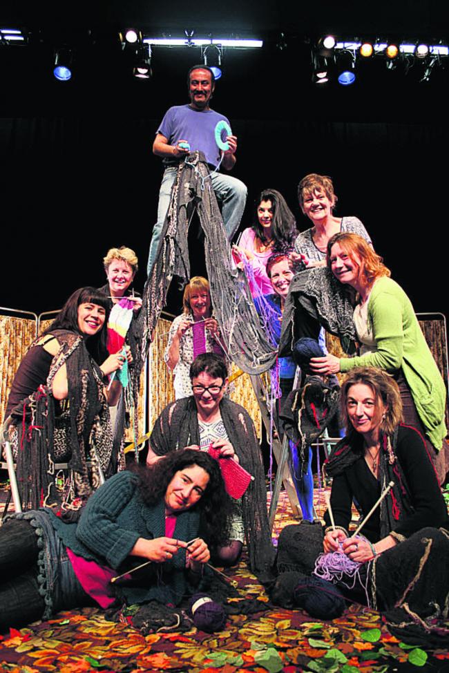 The Knitting Circle’s Sanjiv Hayre is pictured on the ladder with fellow cast members, the writer, crew and volunteer knitters
