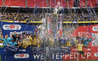 Oxford United players celebrate the League One play-off final victory at Wembley