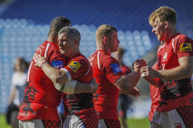 THE END: Welsh skipper Tom May consoles a teammate following their defeat by Saracens this year