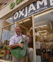 Dave de Paeztron at the Oxfam shop in Broad Street, with the travelling green guitar