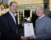 Village Shop of the Year judge, Chris Coe, left, hands the award to Alan Chubb