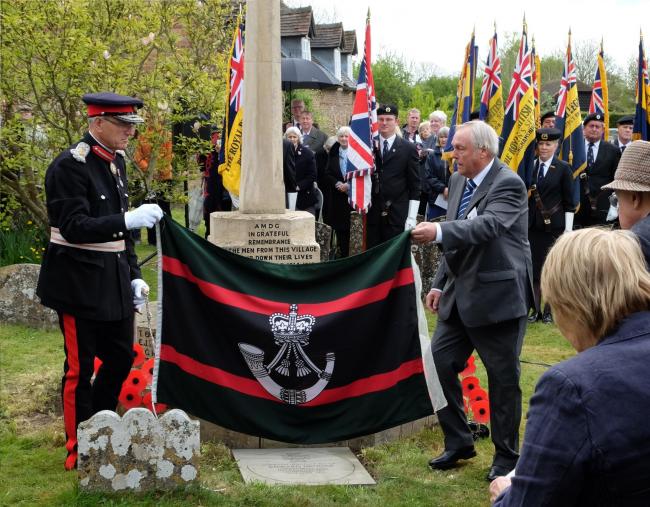 Horspath resident Keith Brooks unveils a paving stone to commemorate his war hero grandfather Edward Brooks VC in the village of his birth, Oakley in Buckinghamshire on Friday, April 28, 2017. Mr Brooks, right, lifts off the Rifles Regimental flag to reve