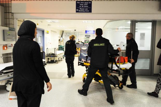 Paramedics bring a patient into A&E at the John Radcliffe Hospital. Picture: Jon Lewis