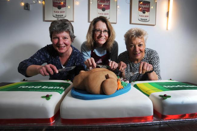 Julia "Happy Cakes," Atkinson, centre has donated these magificent Christmas cakes to the Oxford Food Bank Christmas Day lunch. She is pictured with the food bank's operations manager Cathy Howard, left, and volunteer Fran Gardner.Pic by Jon