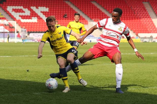 Todd Kane (left) gets forward for Oxford United at Doncaster Rovers  Picture: James Williamson