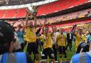 Elliott Moore lifts the League One play-off final trophy