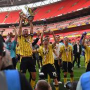 Elliott Moore lifts the League One play-off final trophy